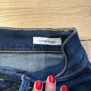 Frame straight leg jeans with frayed hem.